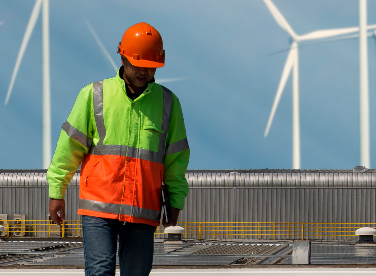 Employee with wind turbines in the background